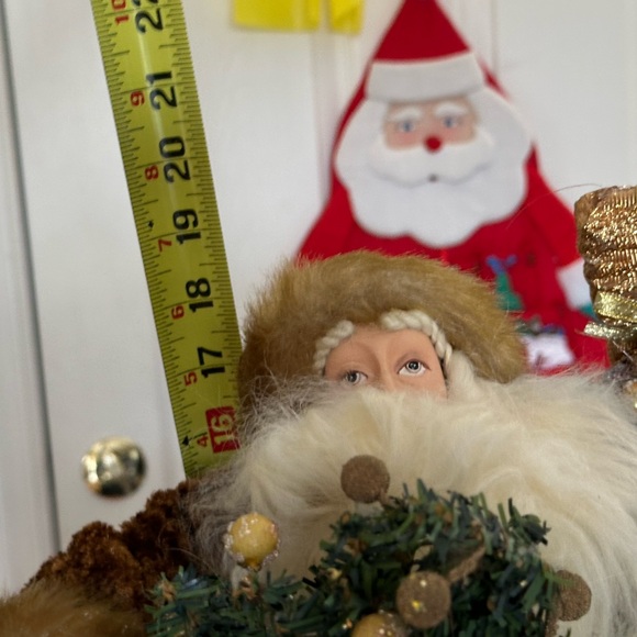 Golden velvet clad Santa holds greenery. - Picture 6 of 7